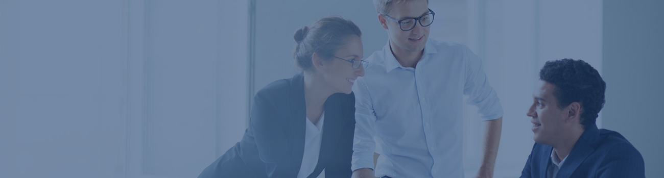 Two professionals collaborating at a desk in an office setting.